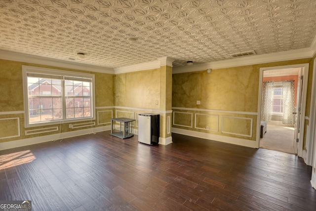 unfurnished room featuring visible vents, ornamental molding, dark wood-style flooring, and an ornate ceiling