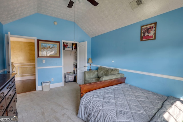 bedroom with light carpet, visible vents, a ceiling fan, vaulted ceiling, and a closet