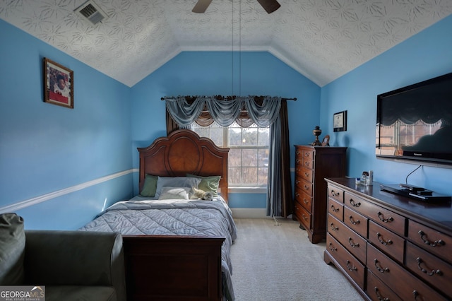 bedroom with a textured ceiling, light colored carpet, a ceiling fan, visible vents, and vaulted ceiling