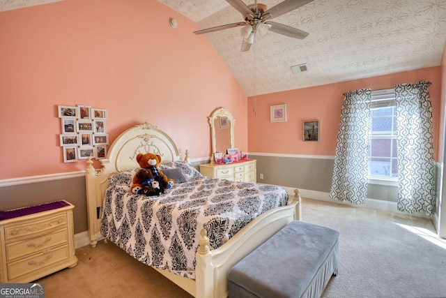 bedroom featuring lofted ceiling, light colored carpet, visible vents, a textured ceiling, and baseboards