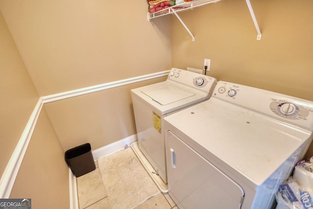 laundry room with laundry area, independent washer and dryer, and tile patterned floors