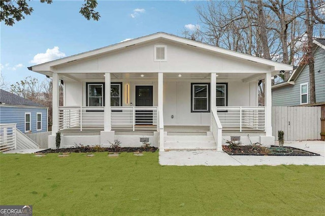 bungalow-style house featuring covered porch and a front yard