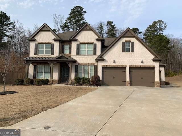 craftsman house with a garage, concrete driveway, and brick siding