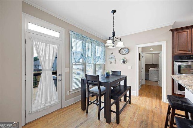 dining room with light wood-type flooring, baseboards, a chandelier, and crown molding