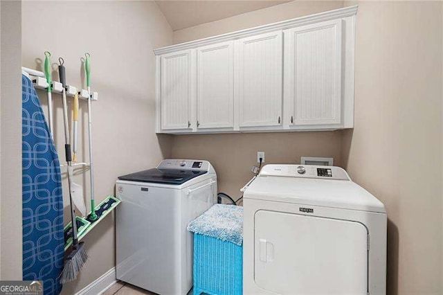 laundry room featuring washing machine and dryer and cabinet space