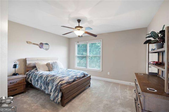 bedroom with ceiling fan, baseboards, and light colored carpet