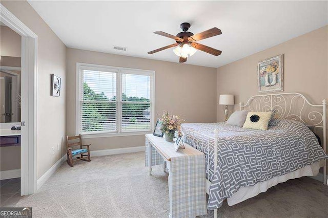 bedroom with a ceiling fan, visible vents, light carpet, and baseboards