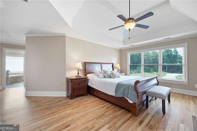 bedroom with crown molding, a raised ceiling, a ceiling fan, light wood-type flooring, and baseboards