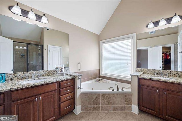 bathroom with vaulted ceiling, two vanities, a sink, and a shower stall