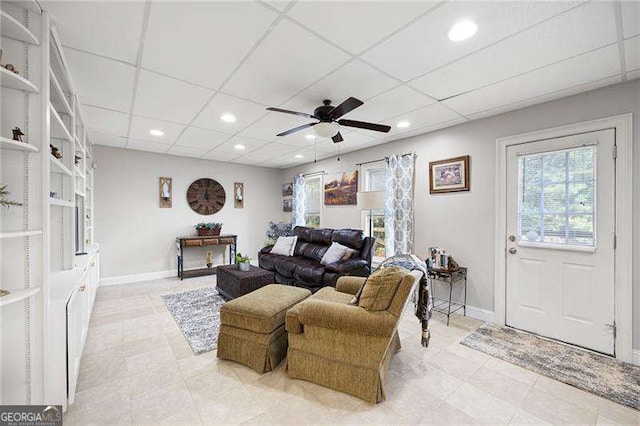 living room with baseboards, a drop ceiling, a ceiling fan, and recessed lighting