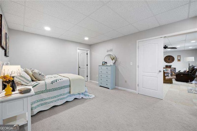 bedroom with a paneled ceiling, recessed lighting, baseboards, and light colored carpet