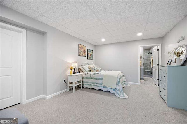 carpeted bedroom featuring recessed lighting, connected bathroom, a paneled ceiling, and baseboards