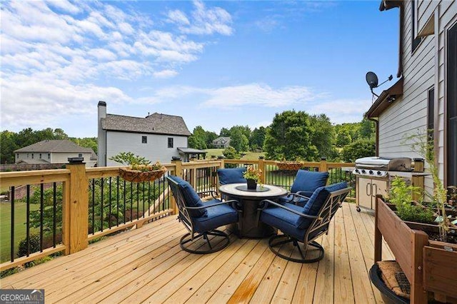 wooden terrace with outdoor dining area