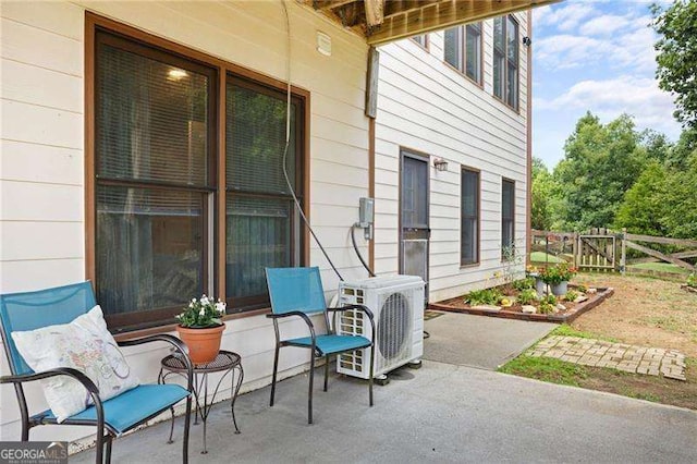 view of patio / terrace featuring ac unit and fence