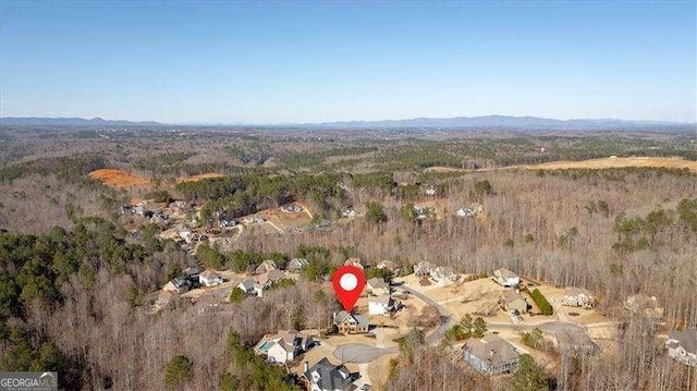 drone / aerial view featuring a view of trees