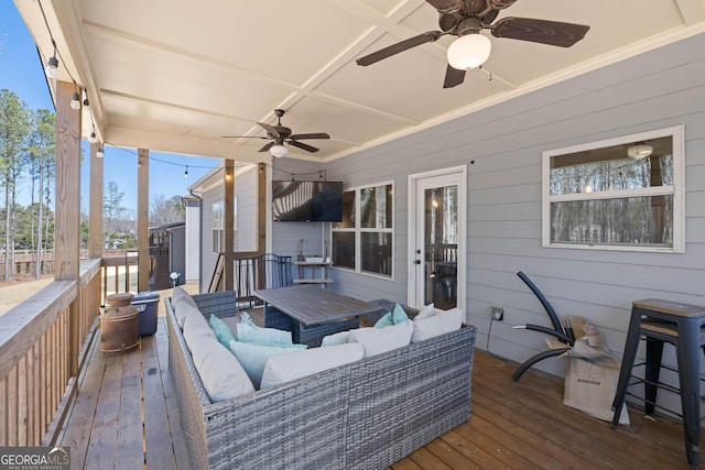 wooden terrace with ceiling fan and outdoor lounge area