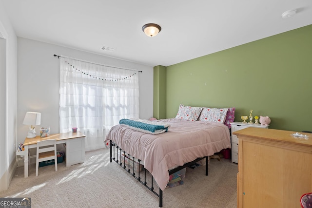 carpeted bedroom featuring visible vents