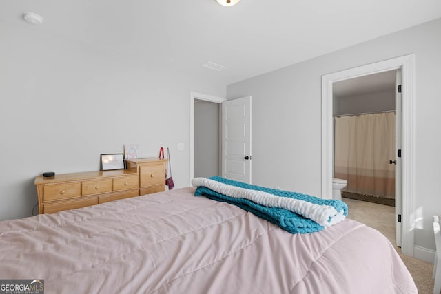 bedroom featuring connected bathroom and visible vents