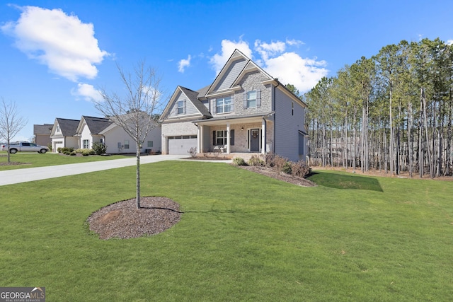 view of front facade with a front yard, concrete driveway, and covered porch