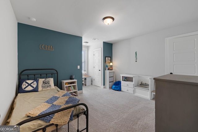 carpeted bedroom featuring visible vents