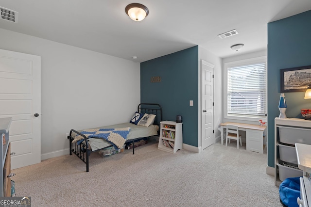 bedroom featuring light colored carpet, visible vents, and baseboards