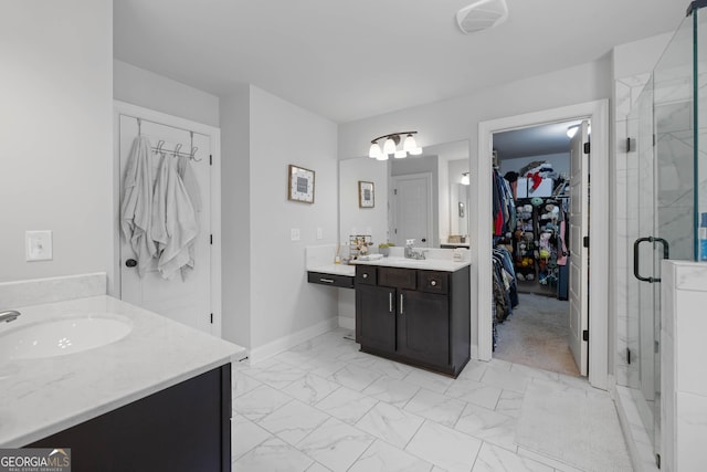 full bathroom featuring baseboards, marble finish floor, a spacious closet, vanity, and a shower stall