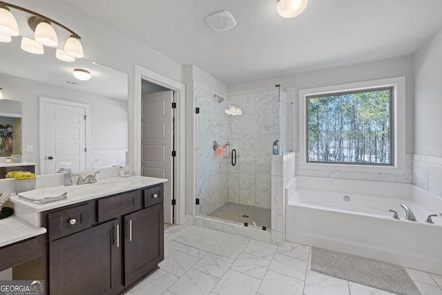 bathroom with visible vents, vanity, marble finish floor, a shower stall, and a bath