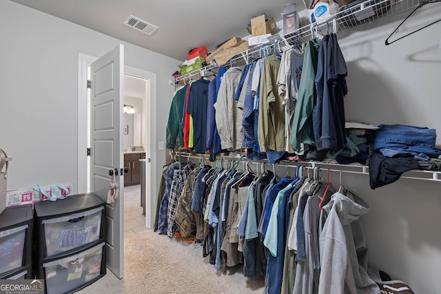 spacious closet with visible vents and carpet flooring