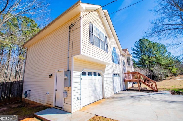 view of side of property featuring an attached garage