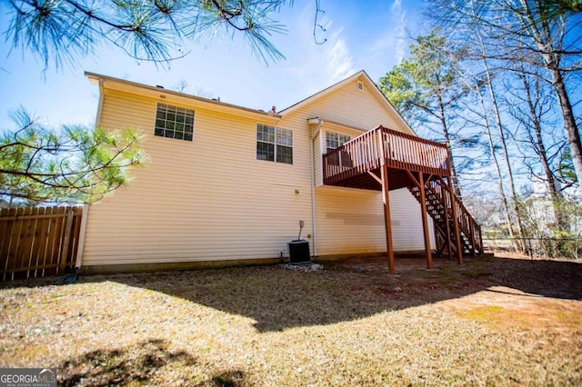 rear view of house with central air condition unit, fence, stairway, and a deck