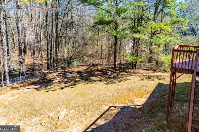 view of yard featuring fence and a deck