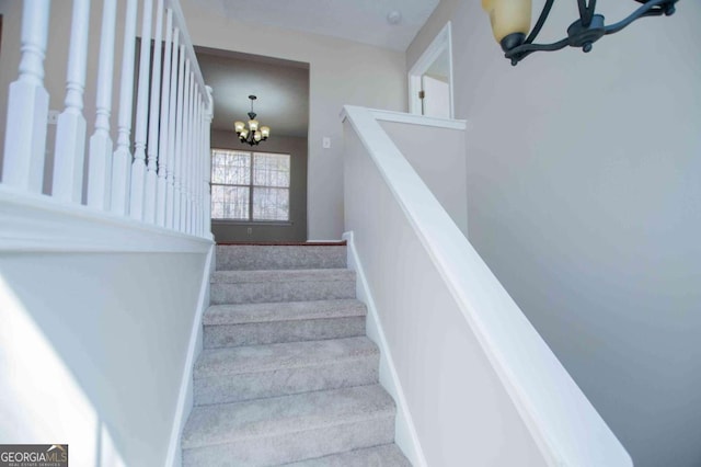 stairs with baseboards and a notable chandelier