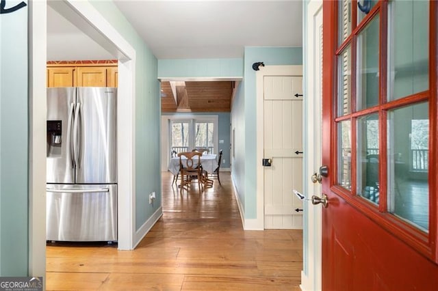 foyer entrance featuring light wood-style flooring and baseboards