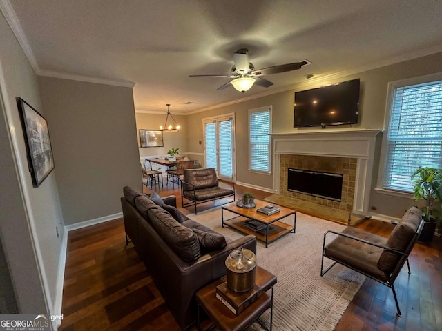 living room featuring ornamental molding, a tile fireplace, dark wood finished floors, and baseboards