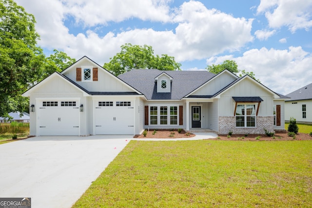 modern inspired farmhouse with concrete driveway, brick siding, board and batten siding, and a front yard