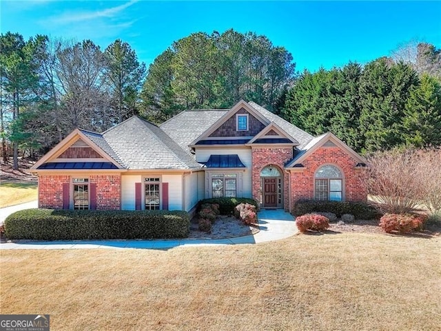 view of front of home featuring a front lawn and brick siding