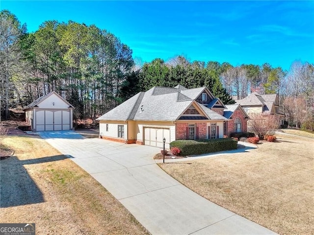 view of front of house featuring an outbuilding, a garage, and a front yard