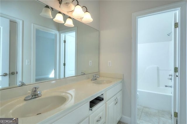 bathroom with tile patterned flooring, a sink, and double vanity