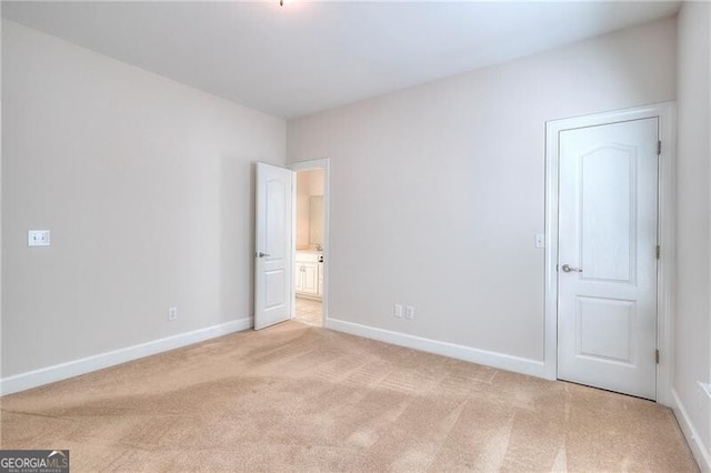 unfurnished bedroom with light carpet and baseboards