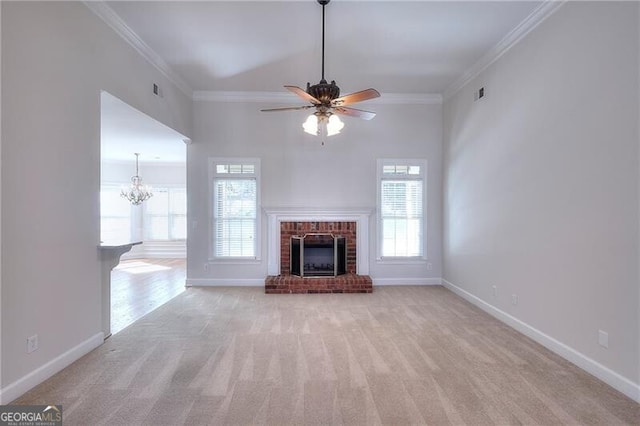 unfurnished living room featuring visible vents, baseboards, crown molding, a fireplace, and ceiling fan with notable chandelier