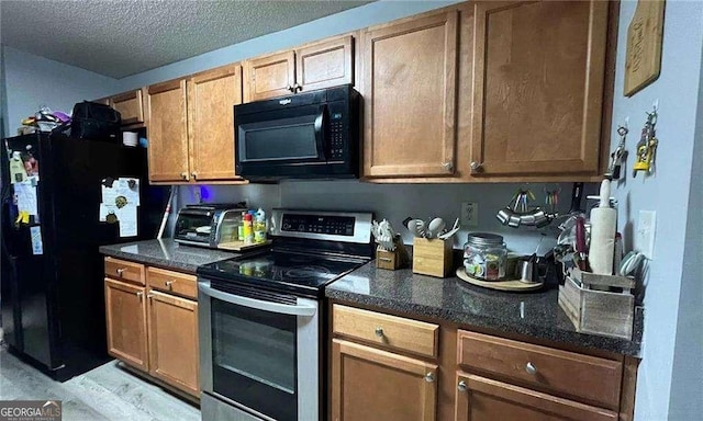 kitchen with black appliances, a toaster, brown cabinets, and a textured ceiling