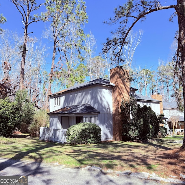 view of property exterior featuring a chimney