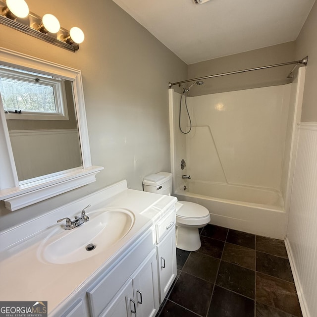 bathroom featuring  shower combination, vanity, and toilet