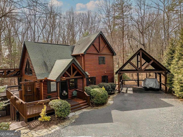 log-style house featuring a shingled roof