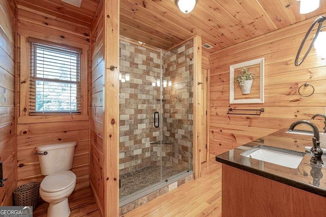 full bath featuring toilet, wooden walls, wood ceiling, vanity, and a shower stall