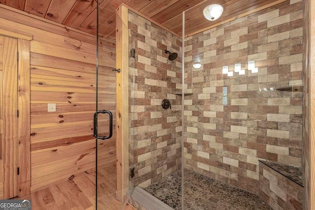 bathroom featuring a shower stall and wood ceiling