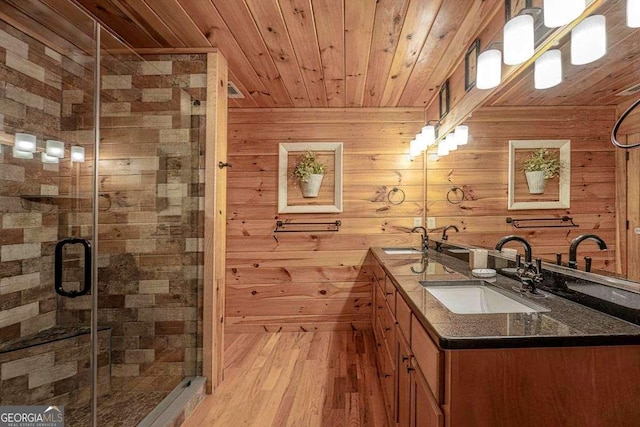 full bathroom featuring double vanity, wood ceiling, wooden walls, and a sink