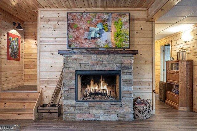 details with an outdoor stone fireplace, wooden ceiling, wooden walls, and wood finished floors