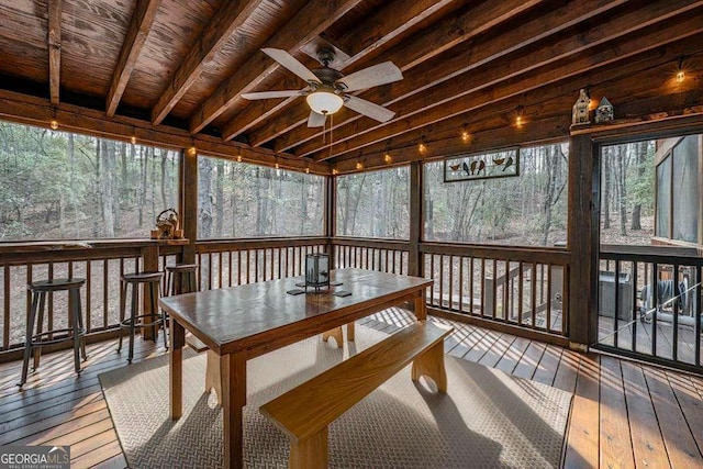 sunroom featuring ceiling fan and vaulted ceiling