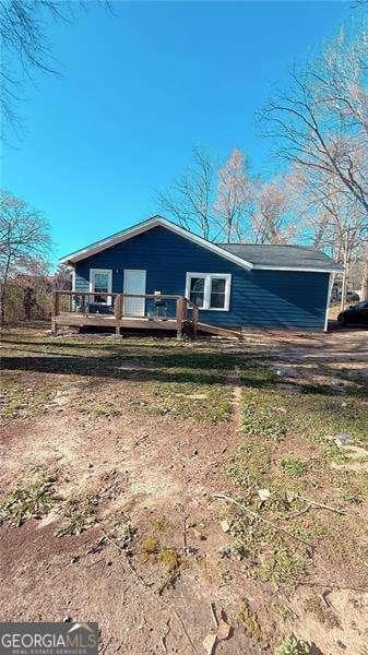 view of front of home featuring a wooden deck